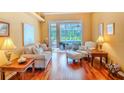 Bright living room with sliding glass doors, hardwood flooring, and cozy furniture at 2417 Valrico Forest Dr, Valrico, FL 33594