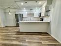 Stylish eat-in kitchen features updated appliances, quartz counters, and ample storage space at 2690 Coral Landings Blvd # 217, Palm Harbor, FL 34684