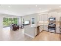 View of the open-concept kitchen and living area with a sliding glass door leading to the outside at 30764 Lindentree Dr, Wesley Chapel, FL 33543