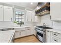 Gourmet kitchen with white cabinets, marble countertops, farmhouse sink and stainless steel appliances at 3209 W Morrison Ave, Tampa, FL 33629