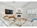 Cozy living room featuring white brick walls, fireplace and comfortable sectional sofa at 3209 W Morrison Ave, Tampa, FL 33629