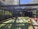 Outdoor enclosed patio featuring an artificial grass floor with shaded area, perfect for relaxation and activities at 32348 Marchmont Cir, Dade City, FL 33523