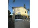 Two-story home with ground floor screened garage and white siding at 3338 Fernleaf Dr, Hernando Beach, FL 34607