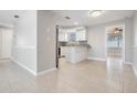 Open concept kitchen with granite countertops, white cabinets, stainless appliances and easy access to other living spaces at 3445 Pinehurst Dr, Holiday, FL 34691