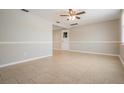 Spacious living room featuring tile floors, neutral paint, and abundant natural light at 3445 Pinehurst Dr, Holiday, FL 34691