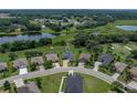 Aerial view of a single Gathering home nestled amongst trees and ponds in a desirable community, providing a peaceful retreat at 34652 Heavenly Ln, Dade City, FL 33525