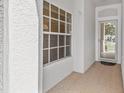 Bright foyer with a window and glass front door allowing natural light at 3512 Tealwood Cir, Palm Harbor, FL 34685