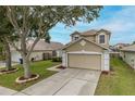 Charming two-story home with a well-maintained lawn and a spacious two-car garage at 4228 Savage Station Cir, New Port Richey, FL 34653