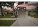 Inviting two-story home with a neutral exterior, two-car garage, and well-maintained front lawn at 4228 Savage Station Cir, New Port Richey, FL 34653