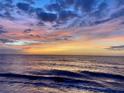 Scenic ocean view at sunset with colorful sky reflecting on the calm water, creating a serene atmosphere at 440 89Th Ave, St Pete Beach, FL 33706
