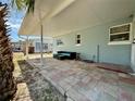 Covered patio featuring a comfortable outdoor seating arrangement and a neatly paved brick floor for relaxation at 440 89Th Ave, St Pete Beach, FL 33706