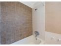 Bathroom featuring a shower with brown and white tiled walls, and shower head at 513 88Th N Ave, St Petersburg, FL 33702