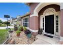 Inviting home entrance featuring decorative landscaping and sidelights at 5860 War Admiral Dr, Wesley Chapel, FL 33544