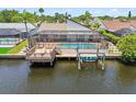 Waterfront home featuring a private pool, dock, and boat lift for easy access to waterways at 6119 Galleon Way, Tampa, FL 33615