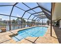 Enjoy waterfront views from this screened in pool with access to the canal and dock at 6119 Galleon Way, Tampa, FL 33615