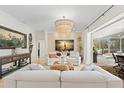 Bright living room with luxury decor opens to the outdoor pool and dining area at 703 Monte Cristo Blvd, Tierra Verde, FL 33715