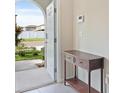 Foyer view with tile flooring, entry table, and natural light streaming in at 7170 Samuel Ivy Dr, Tampa, FL 33619