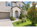 Inviting front door with a covered porch and landscaped garden at 7170 Samuel Ivy Dr, Tampa, FL 33619