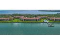Beautiful aerial view showcasing waterfront condos, a pool, a private dock, and scenic bay views at 7520 Sunshine Skyway S Ln # 109, St Petersburg, FL 33711