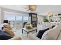Bright living room featuring modern decor, a fireplace, and large windows with stunning water views at 7520 Sunshine Skyway S Ln # 109, St Petersburg, FL 33711
