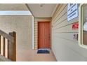 Welcoming orange front door with key features, ensures convenient entry for residents at 9481 Highland Oak Dr # 1511, Tampa, FL 33647