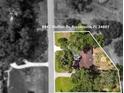 An aerial shot of the property showcasing the house, its location, the surrounding landscape, and backyard at 9542 Wallien Dr, Brooksville, FL 34601