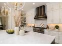 Bright kitchen features white cabinets, stainless steel appliances, and a marble island at 4111 W Swann Ave, Tampa, FL 33609