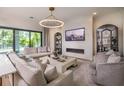 Cozy living room featuring a modern fireplace, plush seating, and an elegant chandelier at 4111 W Swann Ave, Tampa, FL 33609