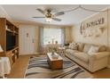 Inviting living room featuring a comfortable sofa, stylish rug, and natural light from a window at 10031 Cherry Creek Ln, Port Richey, FL 34668