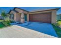 Charming single-story home featuring a manicured lawn and two car garage at 10245 Shady Preserve Dr, Riverview, FL 33578