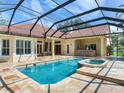 Screened-in pool and spa with stone pavers and outdoor bar, perfect for entertaining at 10504 Echo Lake Dr, Odessa, FL 33556