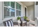 Inviting covered porch with wicker seating offering a cozy outdoor space at 11510 Quiet Forest Dr, Tampa, FL 33635