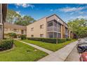 Exterior angle view of condo building with well maintained green lawn at 11816 Raintree Lake Ln # B, Tampa, FL 33617