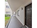 Condo building exterior hallway with brown door at 11816 Raintree Lake Ln # B, Tampa, FL 33617