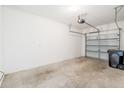 Spacious two car garage with concrete floors, with the garage door slightly open at 11839 Castine St, New Port Richey, FL 34654
