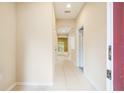 Neutral hallway leading to other rooms, featuring tiled floors and light walls at 11839 Castine St, New Port Richey, FL 34654