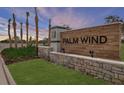 Palm Wind community entrance sign with stone base and lush green landscaping at 12443 Gust Ct, Hudson, FL 34669