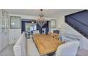 Elegant dining room features a wooden table, chandelier, and banquette seating at 12468 Empire Dr, Seminole, FL 33772
