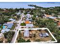 Aerial view of property, neighborhood, water views, and lush surrounding trees, perfect location at 1412 Coburn Dr, Tarpon Springs, FL 34689