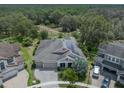 This aerial view features the beautiful home, neighborhood, and solar panels at 14223 Lambert Bridge Ln, Lithia, FL 33547