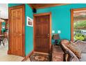 A vivid living room featuring wood trim, classic furniture, and an adjacent doorway at 15012 N 301 Hwy, Thonotosassa, FL 33592