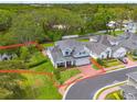 An elevated shot highlighting the property boundaries of this well-manicured home near a pond at 152 Glenn Moor Cir, Dunedin, FL 34698