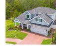 A beautiful exterior of the home, set on a landscaped lot with proximity to a tranquil pond at 152 Glenn Moor Cir, Dunedin, FL 34698