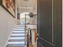 Grand foyer showcasing an elegant staircase with wooden banister and a view into the home's interior at 17 Franklin S Ct # C, St Petersburg, FL 33711