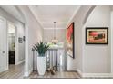 Bright foyer featuring staircase, modern chandelier, and an art niche, creating a welcoming entry at 17 Franklin S Ct # C, St Petersburg, FL 33711