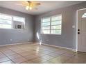 Bright living room featuring neutral walls, tile flooring, and lots of natural light from the windows at 2038 16Th S St, St Petersburg, FL 33705