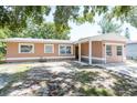 Charming single-story home with a covered porch and well-maintained lawn at 2121 23Rd Sw St, Largo, FL 33774
