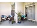 Inviting front porch with comfortable seating, decorative pillows, plants, and a stylish welcome mat at 2227 North Creek Ct, Sun City Center, FL 33573