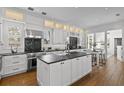 Bright kitchen with white cabinetry, black marble countertops, and stainless steel oven at 2603 Sanders Dr, Tampa, FL 33611