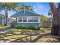 Charming blue bungalow featuring large windows and a well-maintained front lawn at 2720 14Th N Ave, St Petersburg, FL 33713